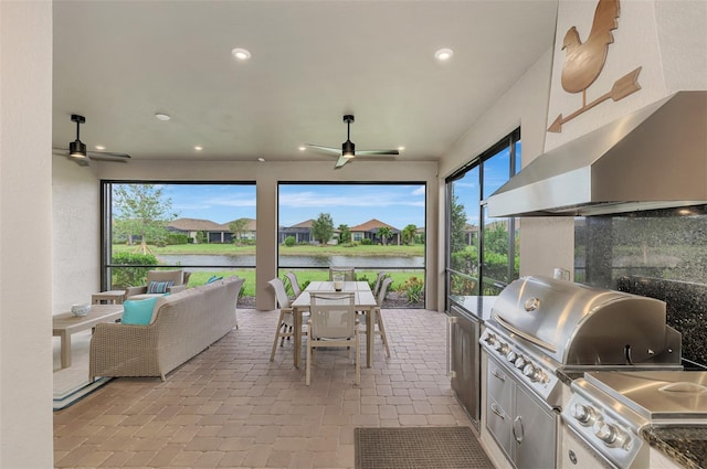 view of patio / terrace with ceiling fan, a grill, and a water view