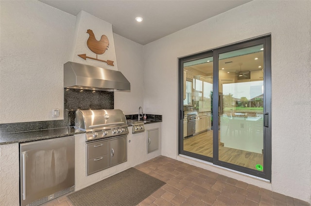 view of patio featuring area for grilling and sink