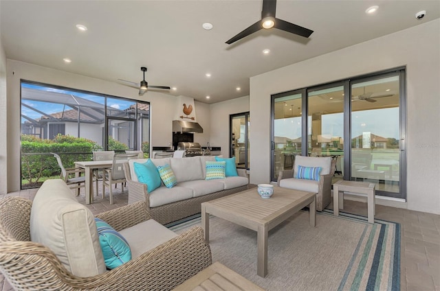 view of patio / terrace with a lanai, outdoor lounge area, and ceiling fan