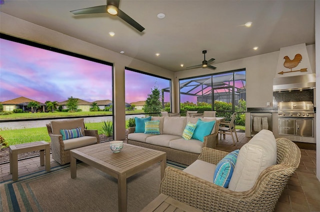 sunroom / solarium with a water view and ceiling fan