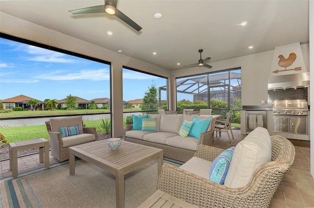 sunroom featuring a water view