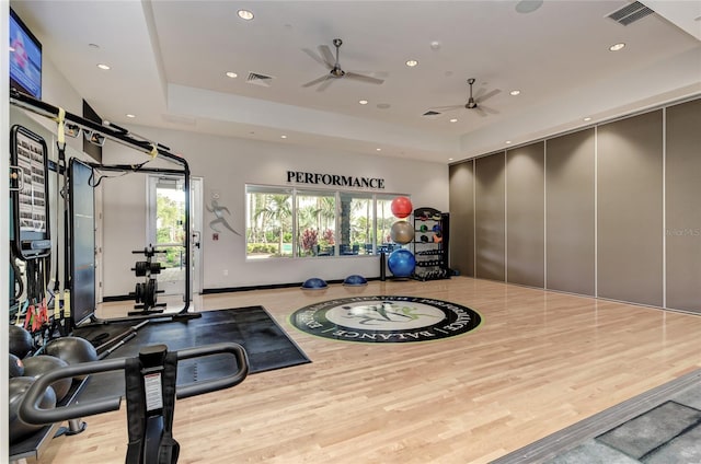 exercise room with light wood-type flooring and ceiling fan