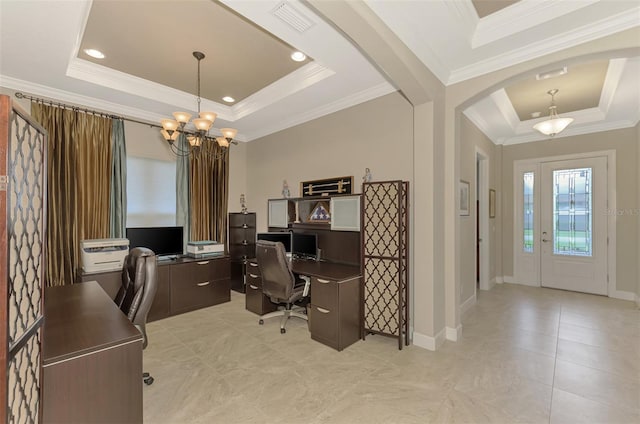 office space featuring ornamental molding, a tray ceiling, and an inviting chandelier