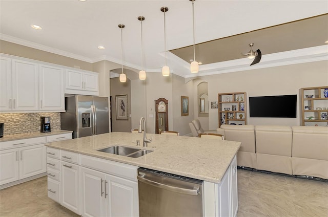 kitchen featuring white cabinetry, hanging light fixtures, and stainless steel appliances