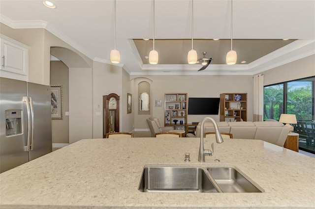 kitchen featuring sink, decorative light fixtures, stainless steel fridge, and crown molding