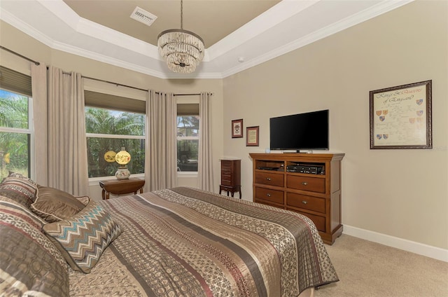 carpeted bedroom featuring ornamental molding, multiple windows, a tray ceiling, and an inviting chandelier