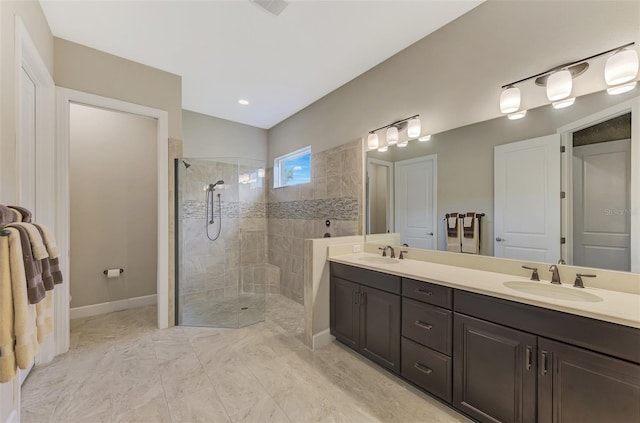 bathroom with vanity and tiled shower