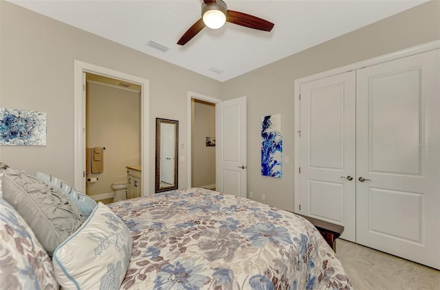 carpeted bedroom featuring ceiling fan, connected bathroom, and a closet