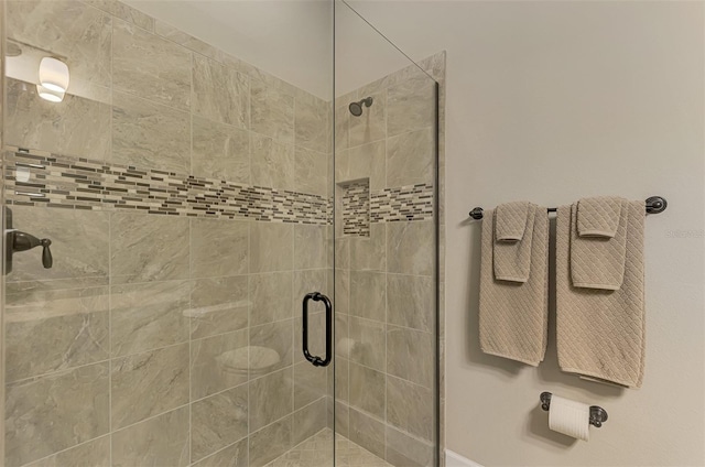 bathroom with a shower with door