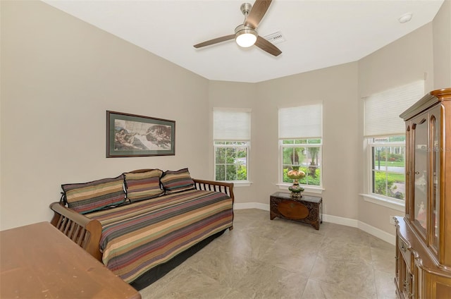 bedroom with multiple windows and ceiling fan