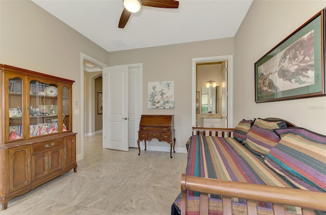 bedroom featuring ceiling fan and connected bathroom