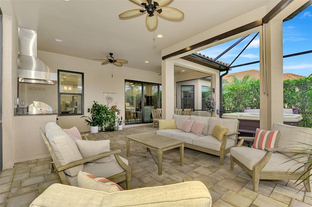 view of patio with ceiling fan, glass enclosure, and an outdoor living space