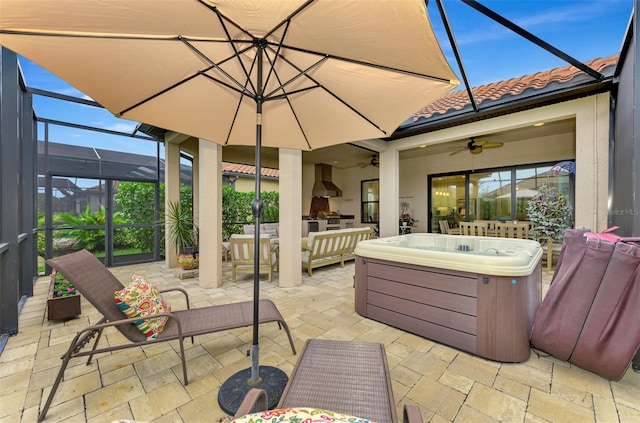 view of patio / terrace featuring a hot tub, outdoor lounge area, a lanai, and ceiling fan