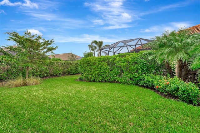 view of yard featuring glass enclosure