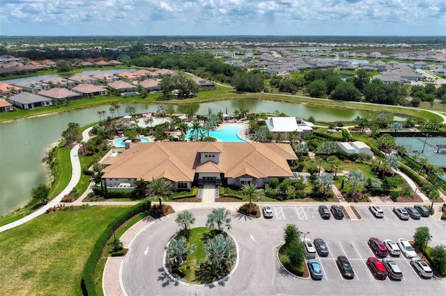 aerial perspective of suburban area with a large body of water and a pool area