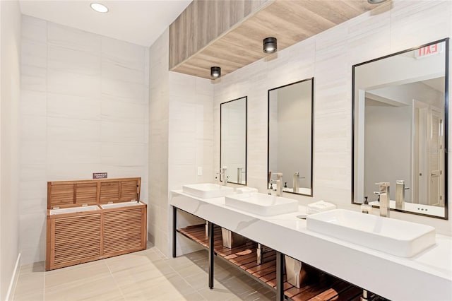 full bathroom featuring tile walls, tile patterned flooring, double vanity, and recessed lighting