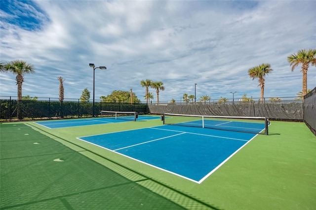 view of tennis court featuring fence