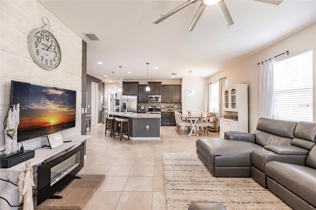 living area with recessed lighting, visible vents, ceiling fan, and light tile patterned floors