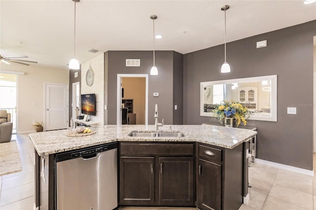 kitchen with open floor plan, stainless steel dishwasher, a sink, and light stone counters