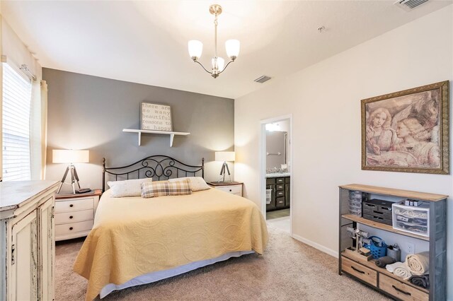 bedroom with a chandelier, light carpet, visible vents, baseboards, and ensuite bath