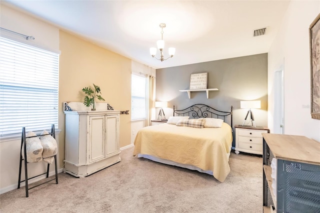 bedroom featuring a notable chandelier, baseboards, visible vents, and light colored carpet