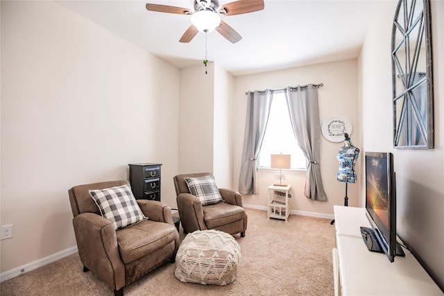 sitting room with carpet, baseboards, and a ceiling fan