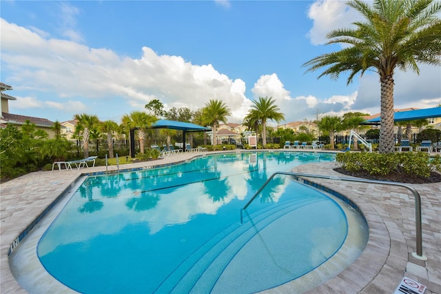 pool featuring a patio and fence