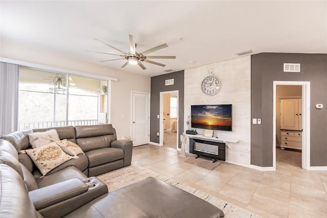 living room with visible vents, ceiling fan, and baseboards