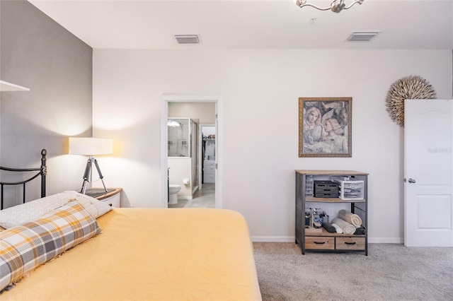 carpeted bedroom with ensuite bath, visible vents, and baseboards