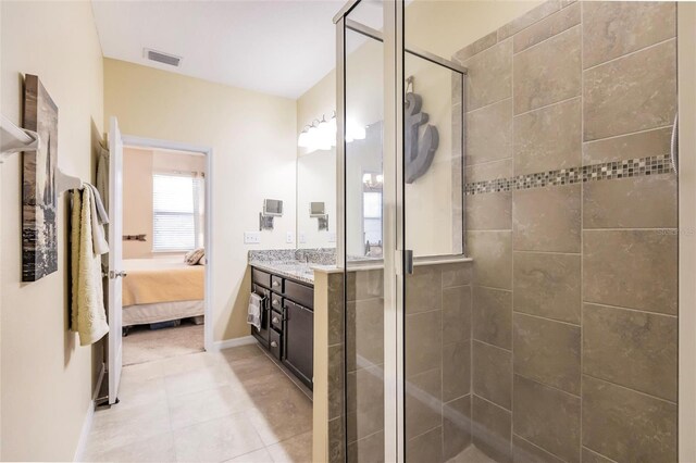 ensuite bathroom featuring visible vents, ensuite bathroom, a shower stall, vanity, and baseboards