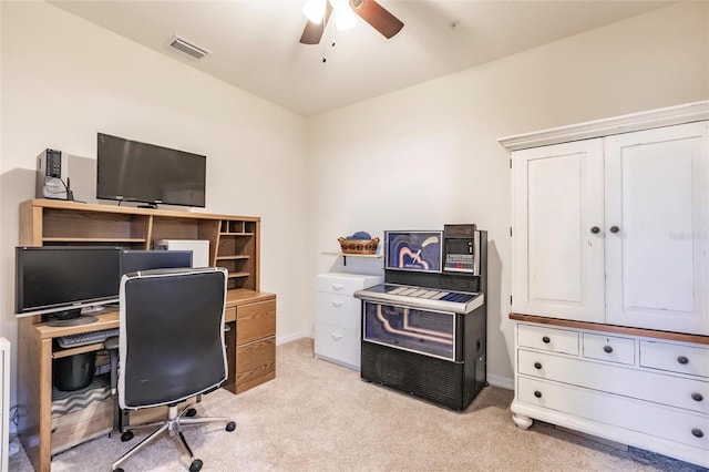 home office with light carpet, ceiling fan, visible vents, and baseboards