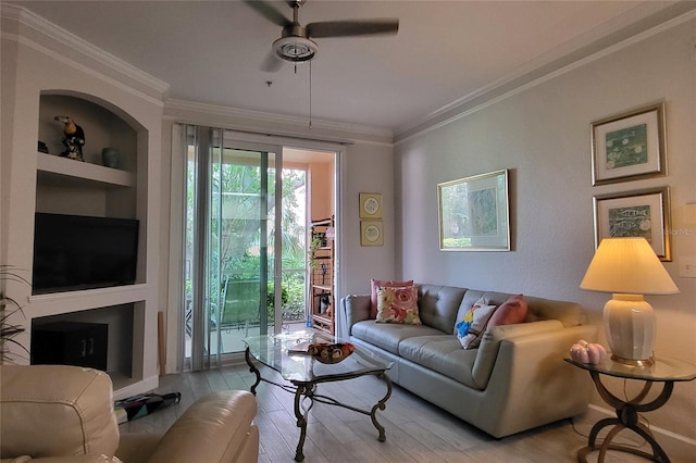 living room with light hardwood / wood-style floors, built in features, ceiling fan, and crown molding