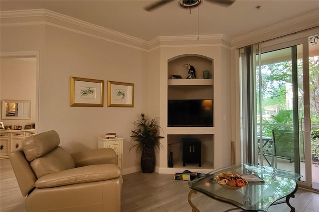 living room featuring ceiling fan, light hardwood / wood-style floors, built in features, and ornamental molding