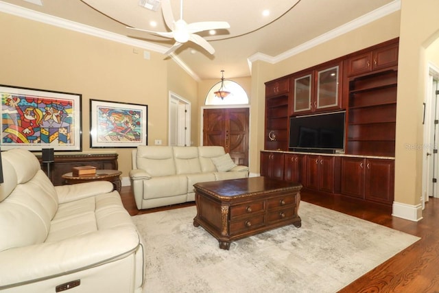 living room featuring wood-type flooring, a chandelier, and ornamental molding