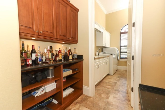 bar with washer / clothes dryer and crown molding