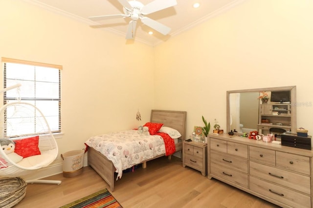 bedroom with ornamental molding, ceiling fan, and light hardwood / wood-style floors