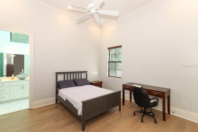 bedroom with ceiling fan, ensuite bath, light wood-type flooring, and crown molding