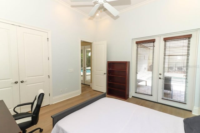 bedroom featuring a closet, french doors, access to exterior, light hardwood / wood-style floors, and ceiling fan