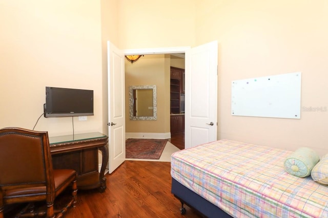 bedroom with dark hardwood / wood-style floors