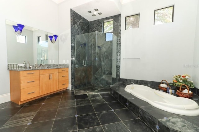 bathroom featuring independent shower and bath, vanity, and tile patterned flooring