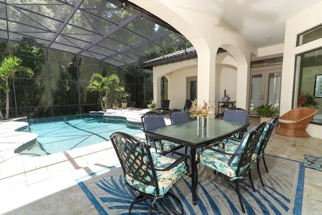 view of pool with french doors, glass enclosure, and a patio area