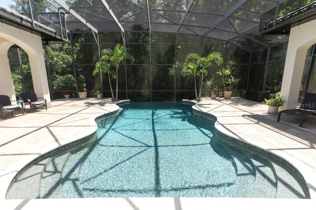 view of swimming pool featuring a lanai and a patio