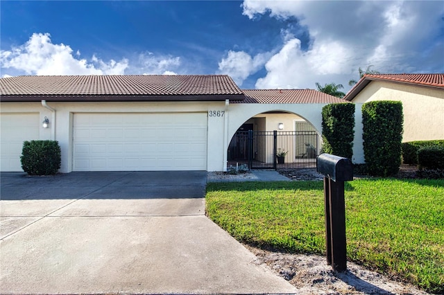 mediterranean / spanish-style house featuring a front lawn and a garage