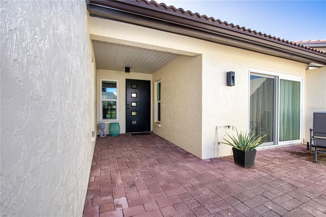 property entrance featuring a patio