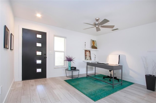 foyer entrance with ceiling fan and light hardwood / wood-style flooring