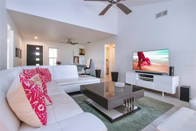 living room with ceiling fan and wood-type flooring