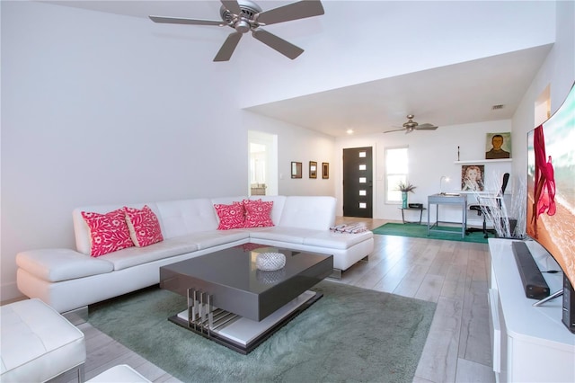 living room featuring ceiling fan and light hardwood / wood-style flooring