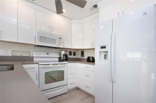 kitchen with white appliances, light hardwood / wood-style floors, white cabinetry, and ceiling fan