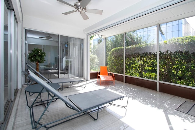 unfurnished sunroom featuring ceiling fan