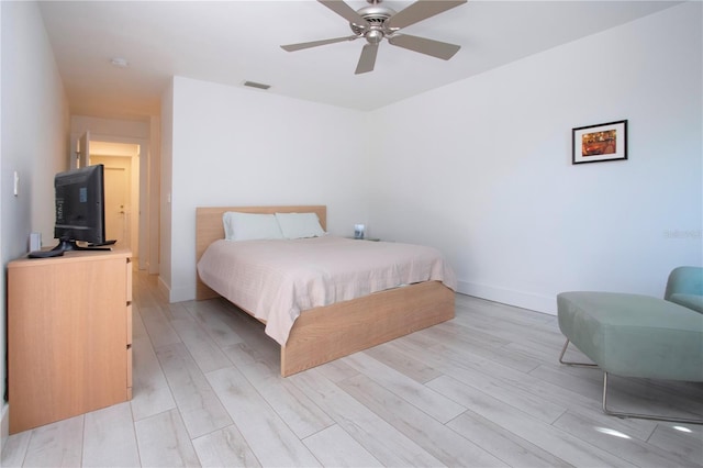 bedroom with light hardwood / wood-style floors and ceiling fan